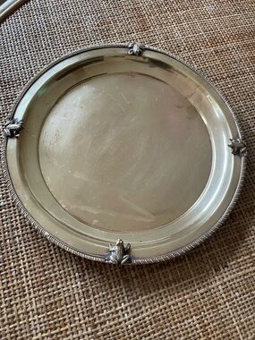 Solid brass tray featuring small frog figures along its edge.